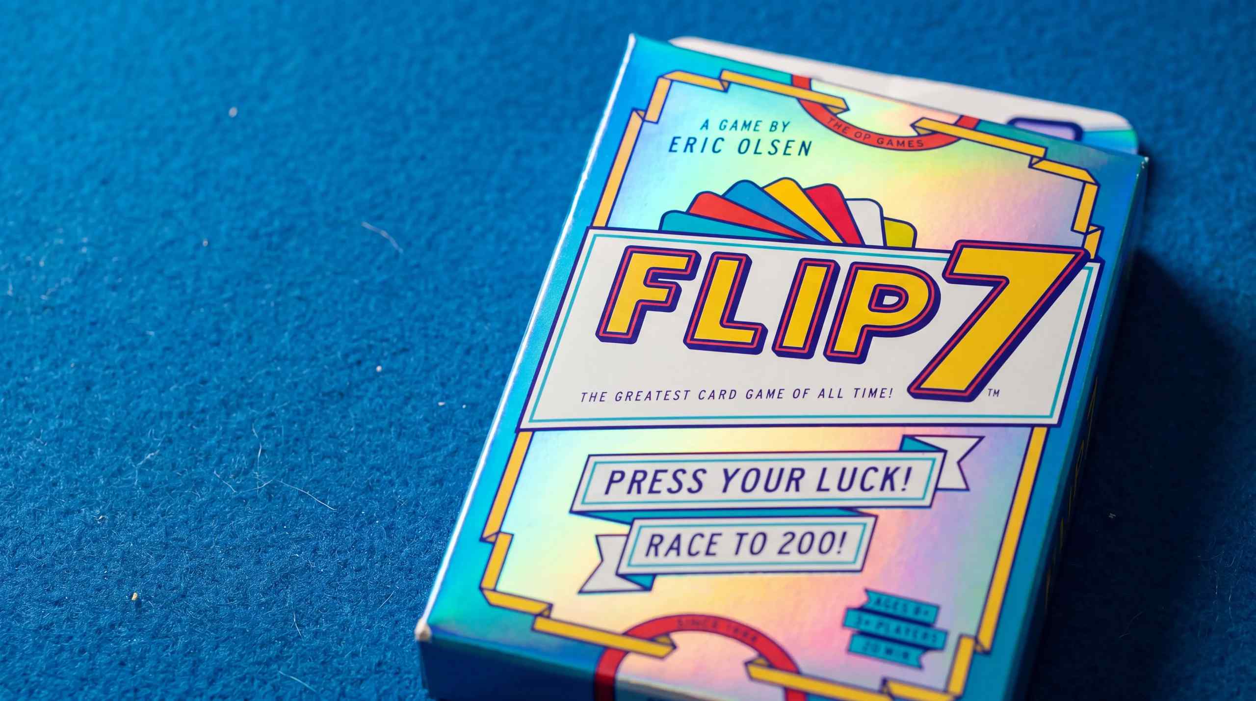 A stylized image of the card game Flip 7 still in the box.